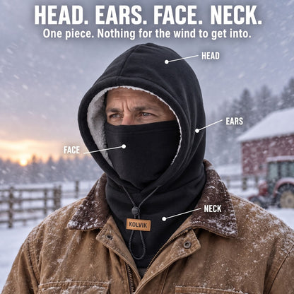 Man on a snowy farm wearing the Kolvik hood, covering head, ears, face and neck